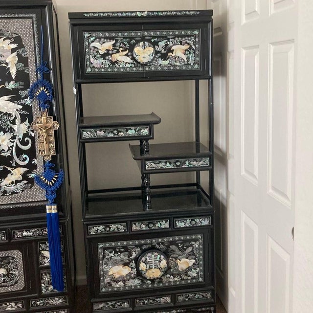 This unique bookshelf features beautiful hand-crafted mother of pearl inlay with bird and floral designs on a sleek black...