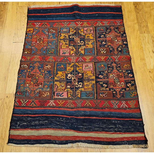 This exquisite Caucasian Soumak kilim, originally crafted as a horse saddle blanket or tent decoration in the fourth...