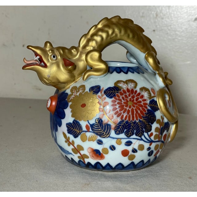 This exquisite vintage Japanese Imari teapot is a testament to the intricate craftsmanship of traditional porcelain art....