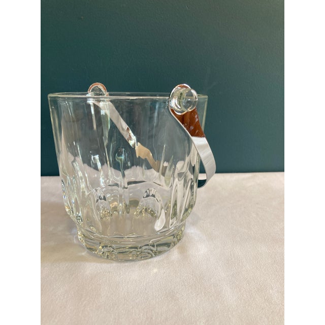 This small ice bucket has cut detail patterns and has a removable silver metal handle. Perfect for your bar setup with...