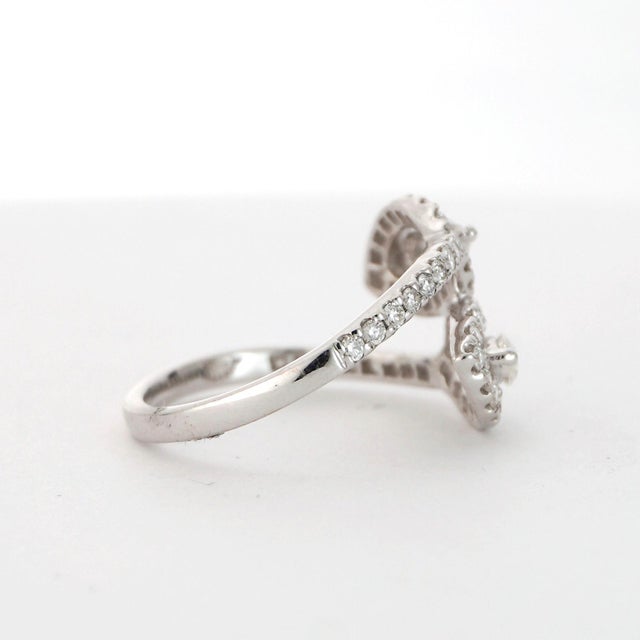 Discover the elegance of our exquisite Diamond Ring. This captivating piece, designed in 18K white gold, features a...