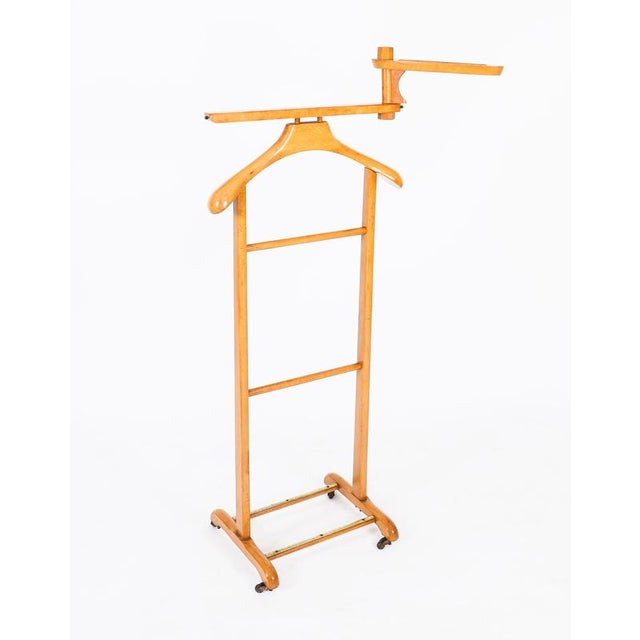 This is an elegant English Edwardian revival walnut gentleman's valet/clothes stand dating from the mid 20th century. The...