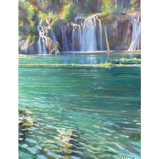 The artwork depicts a serene scene of Hanging Lake, where cascading waterfalls spill into tranquil turquoise waters. The...
