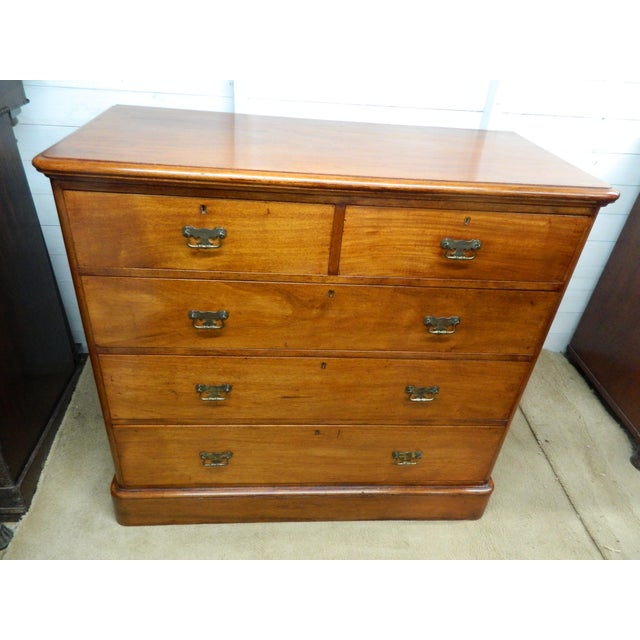 This Victorian Mahogany Chest of Drawers is a beautiful antique piece from the 19th century, featuring a brass handle...