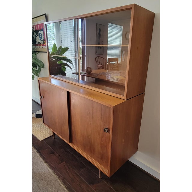 This 1950s Scandinavian teak china cabinet combines elegant modern design with a lower, square profile that fits...