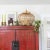Indonesian bamboo and rattan birdcage features hand-carved rosettes and delicate scrolls at the base and crown, a zig-zag...