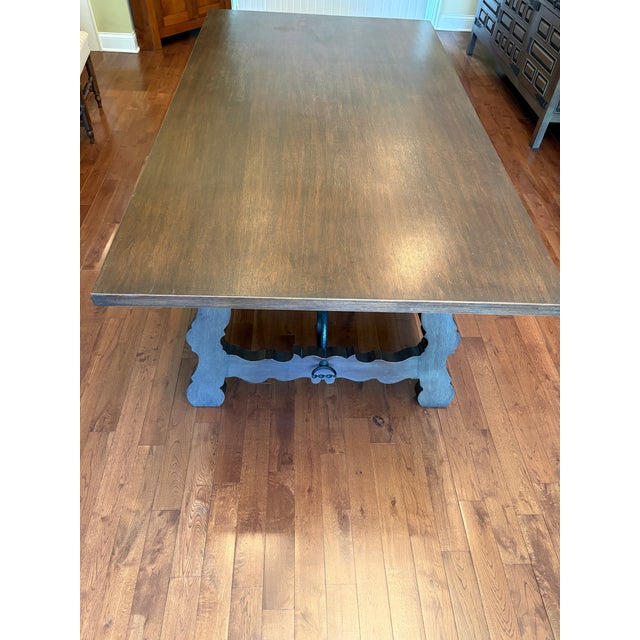 Elegant Spanish Colonial, solid mahogany dining table with a distinctive iron curved stretcher base and sturdy uniquely...