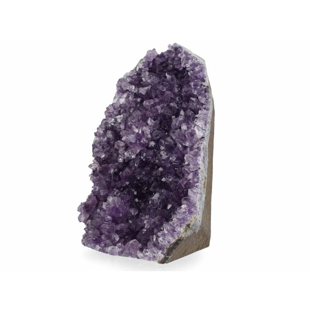 This decorative purple quartz geode is a unique piece that brings the wonders of the natural world indoors. Its...