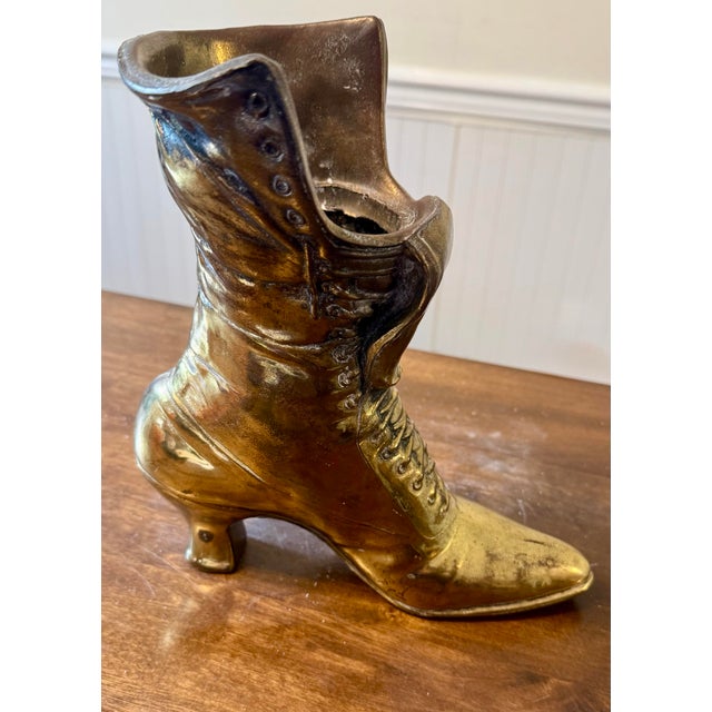 This solid brass shoe is highly versatile and used as a decorative figurine, vase, a unique bookend, or even a doorstop....