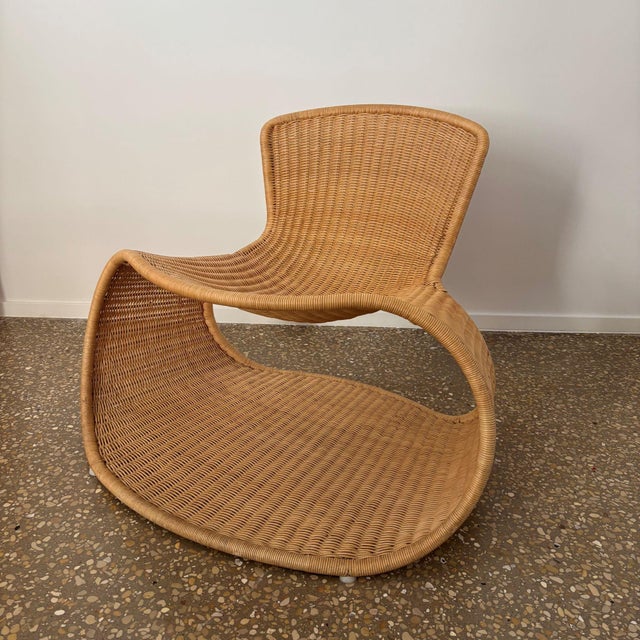 A striking, sculptural lounge chair , ‘sari’ chair, made of woven rattan over a steel frame. designed by industrial...