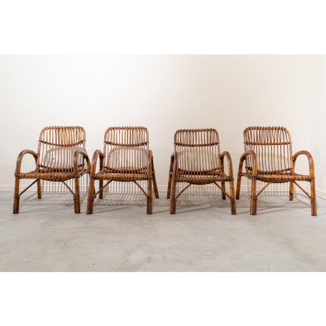 Set of four Italian Mid-century style bamboo chairs from the 1950s. The chair is made from curved bamboo canes arranged...