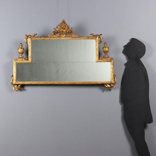 Neoclassical mirror in carved and gilded wood. Two superimposed mirrors enclosed in a molded and carved frame. The...