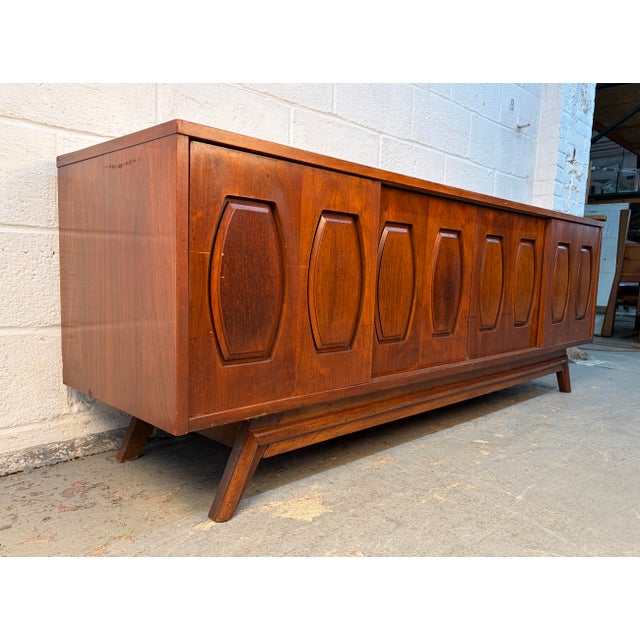 Mid-Century Walnut and Burl Credenza by Young Manufacturing, featuring rich walnut tones, striking burl wood accents, and...
