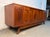 Mid-Century Walnut and Burl Credenza by Young Manufacturing, featuring rich walnut tones, striking burl wood accents, and...