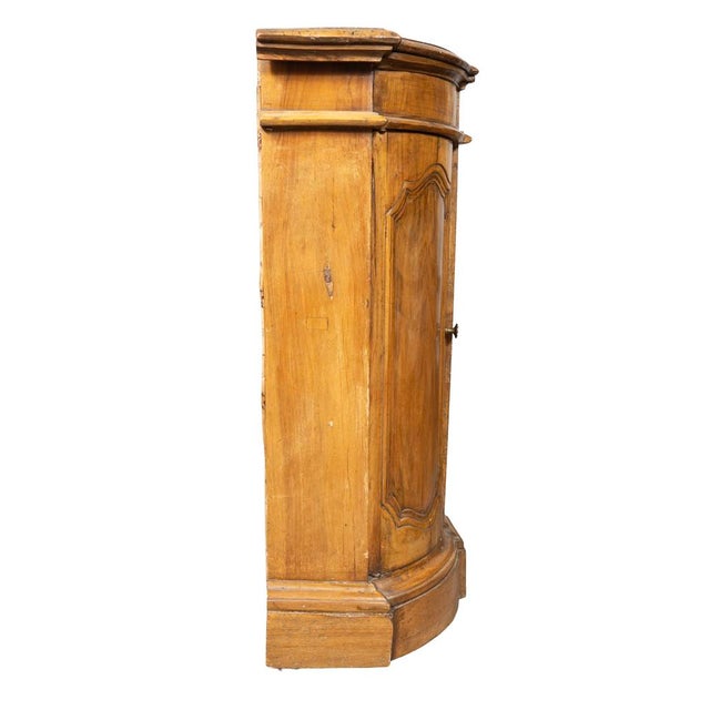 Italian baroque walnut credenza. With shaped top over a conforming case with drawer over central paneled door flanked by a...