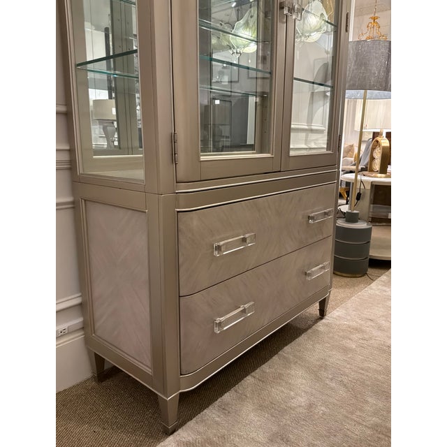 Stylish Pulaski Furniture Champagne Display Cabinet. Acrylic handles, 2 drawers, 3 glass shelves, mirrored back and touch...