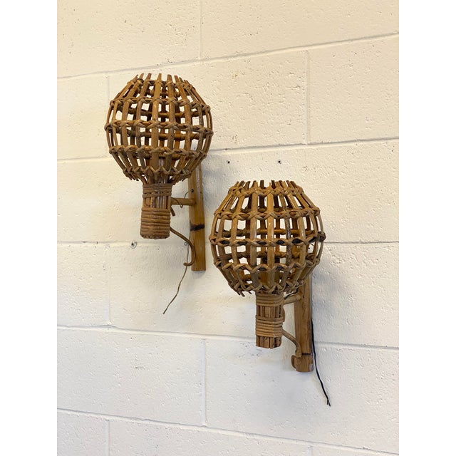 Pair of 1970s rattan and bamboo wall sconces. European Plug (up to 250V).The wiring of this item may be original and might...