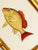 This hand-painted fish is brought to life through warm yellows tones and a striking pop of burnt orange along the fins and...