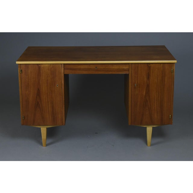A mid-century modern double-sided desk, crafted in Sweden at the turn of the 1950s and 1960s by Svenska Möbelfabrikerna...