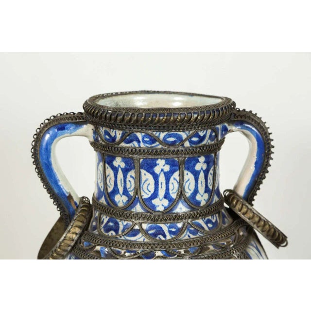 Antique Moroccan Fez Blue & White Ceramic Footed Vase with Filigree Metal Overlay, Early 20th Century. Dimensions: 10 in D...