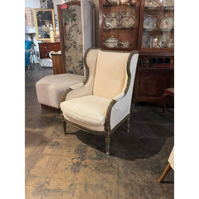 The 19th c. French Louis XVI Carved and Painted Bergere is a timeless and elegant chair. Featuring beautiful carvings and...