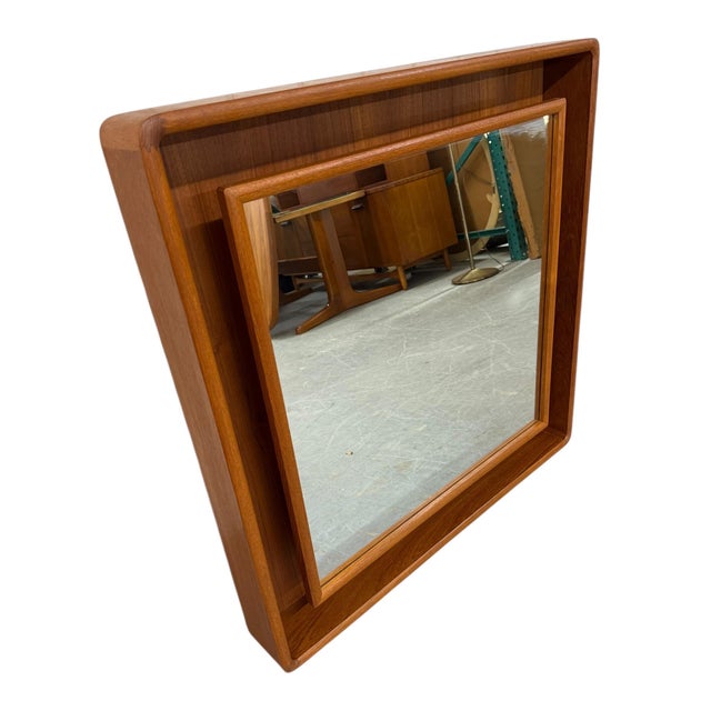 Elevate your space with this vintage circa 1970s Danish Modern teak shadow box lighted wall mirror by Pedersen & Hansen....