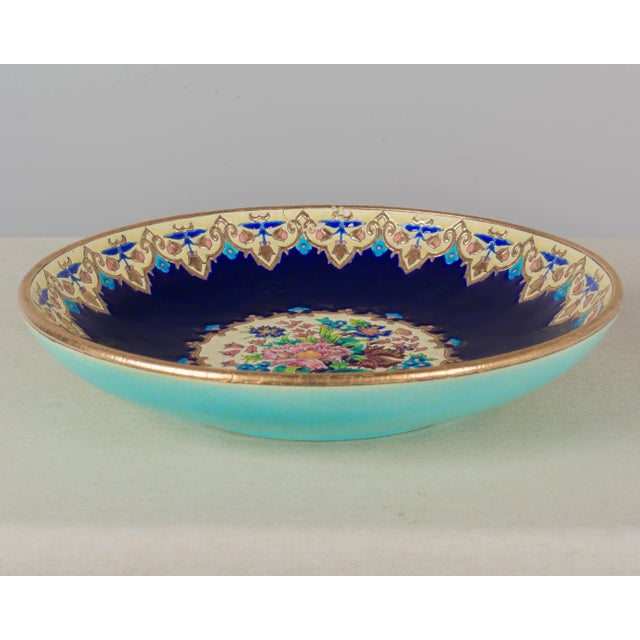 A French Art Deco Longwy large ceramic centerpiece bowl, hand-painted in the style of Chinoiserie cloisonné enamel. Dark...