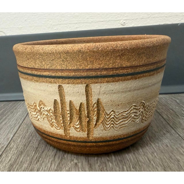 A beautifully crafted vintage stoneware succulent pot featuring raised cactus motifs, sculptural texture, and warm...