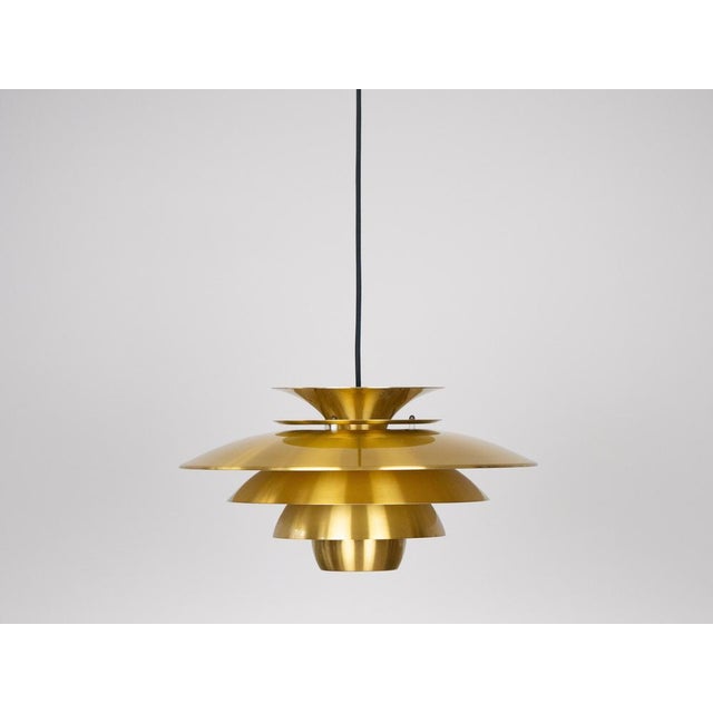 The lamp's form was designed based on the principle of a reflective system that directs light not only downward but also...