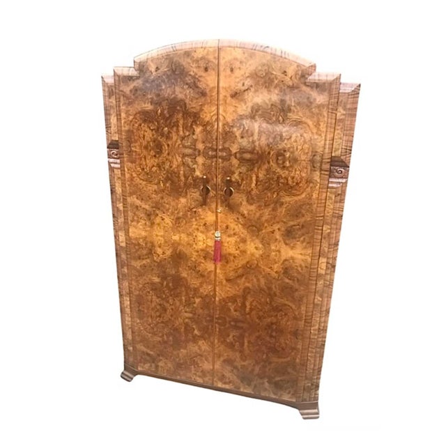 A beautiful example of an Art Deco burr walnut double wardrobe. The Shallow arched top with rounded cross banded borders...