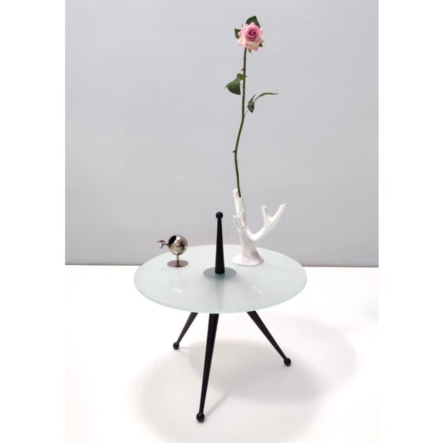 Made in Italy, 1980s. This is a reinterpretation of Cesare Lacca's design of a tripod coffee table in the 50s. This coffee...