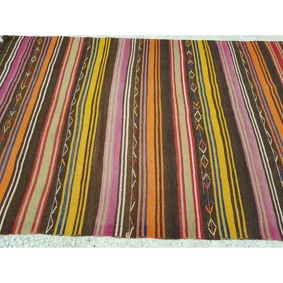 This is a vintage handwoven wool rug from Turkey. The piece was made in the 1970s.