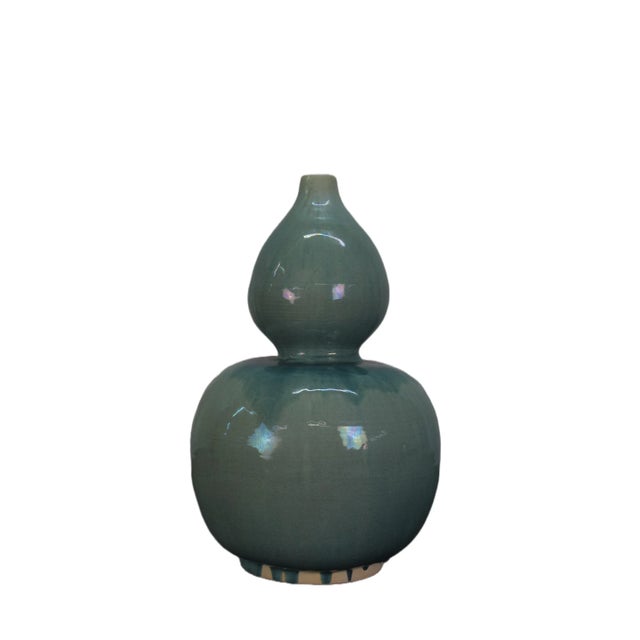 This bottle gourd vase is handmade and glazed. Each has its own unique glazed line and characteristics that only add to...