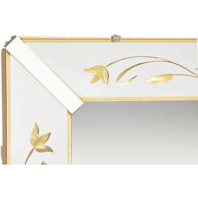 American 1940s Art Deco mirror with canted and mirrored glass frame. Reverse etched and gilt cattails and ivy filigree...