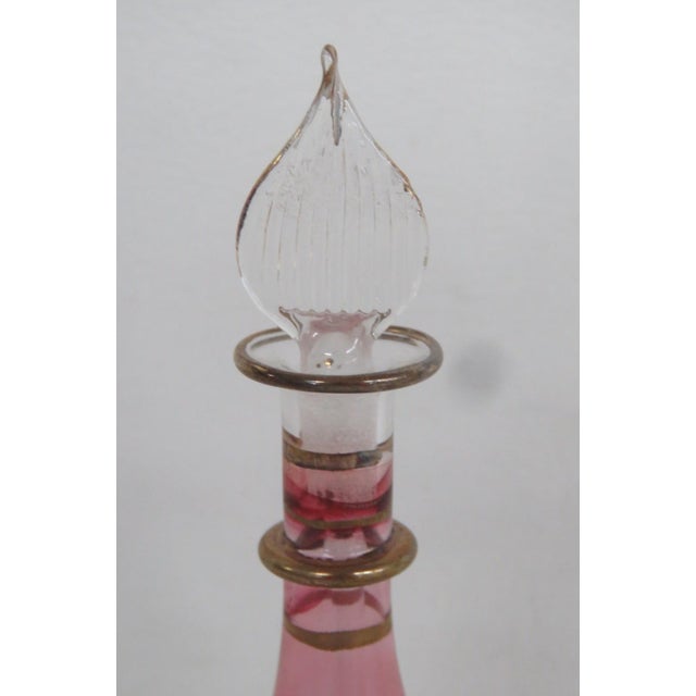 This lovely empty decorative perfume bottle is made out of glass. Due to its style and design, we believe this is Egyptian...