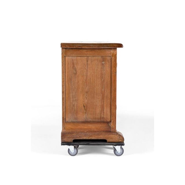 A commanding french oak enfilade or sideboard buffet with a single slab top of carved oak with gently sloping carved...