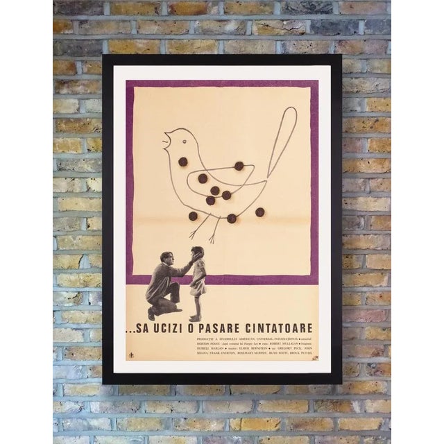 A scarce original poster for the first romanian release of the 1962 american film adaptation of harper lee's 1960 pulitzer...