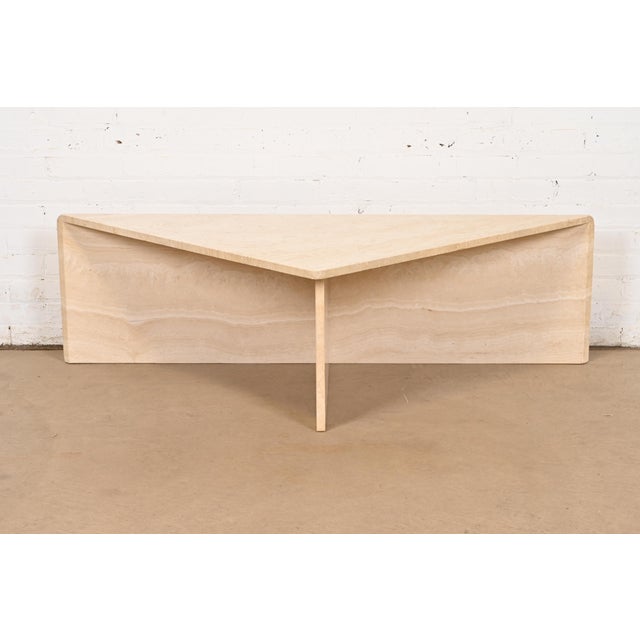An exceptional Modern Italian travertine triangular coffee or cocktail table In the manner of Ello Italy, Circa 1970s...