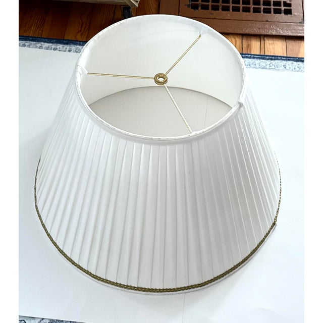 Oversized Frederick Cooper empire pleated lampshade in eggshell with gold trim. Classic eggshell tone with subtle gold...