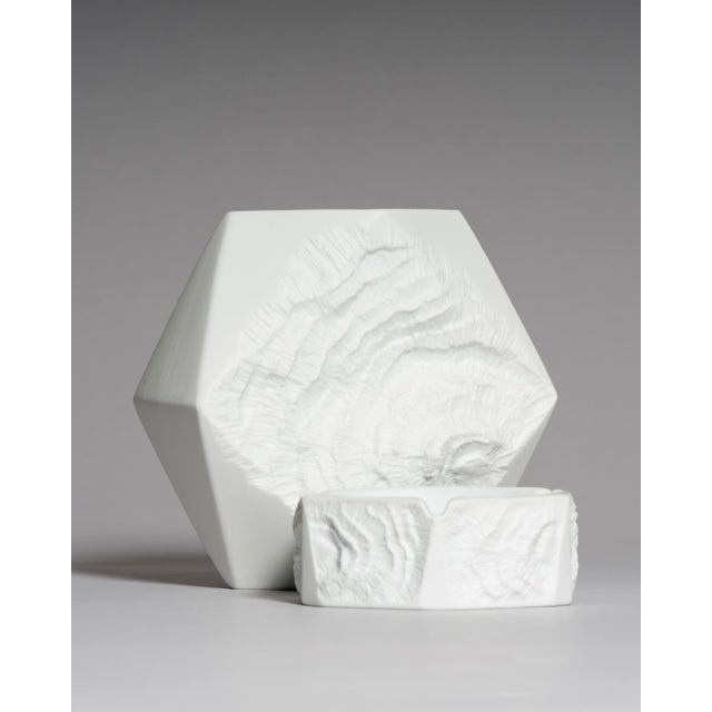 A distinctive two-piece set comprising a sculptural vase and matching ashtray from the fossil relief collection attributed...