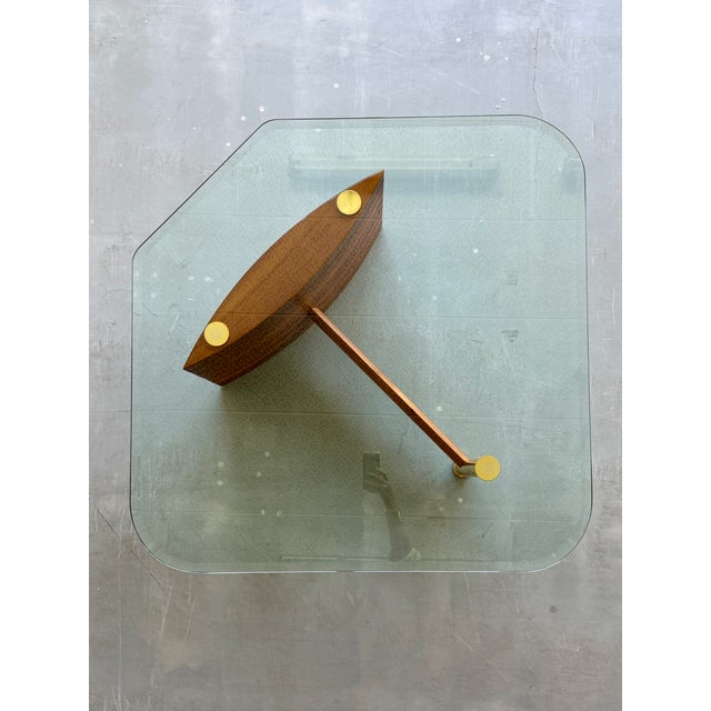 Beautiful German mid century modern walnut and glass coffee table by Hainke, 1970s. The structure and the shape recall the...