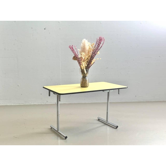 This original kelko folding table impresses with its ingenious folding mechanism and clean, functional design. With just a...