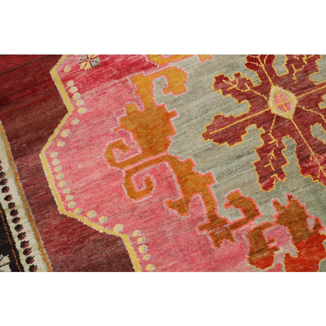 A wild 20th century Turkish Kars square size rug. A large scale floral design featuring a bright pink medallion with a...