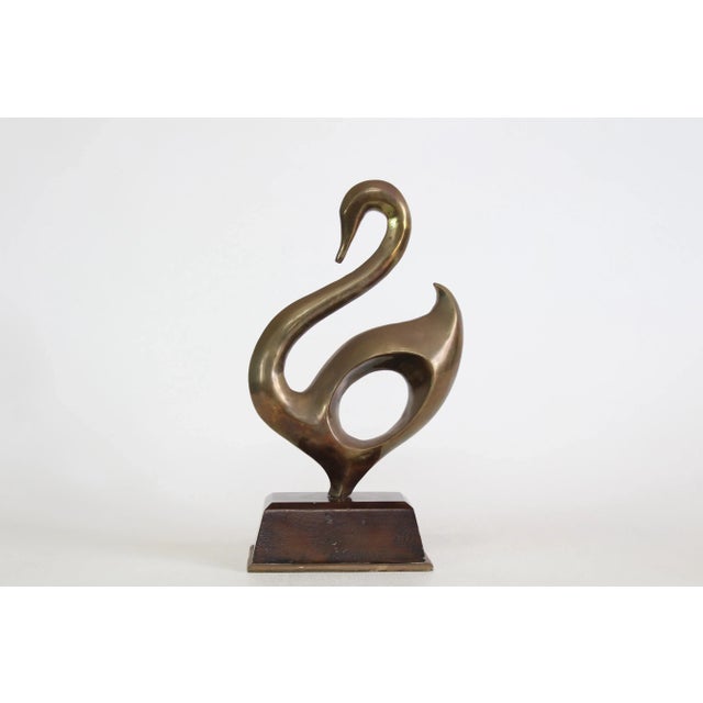 Vintage abstract brass swan sculpture displayed on wood base This sculpture has vintage patina Dimensions; 7" Width x 4"...