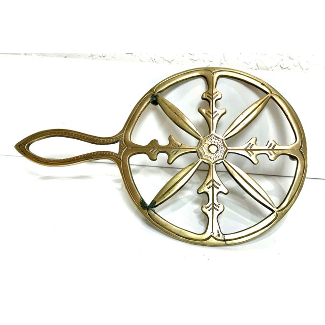 A set of three ornate vintage brass trivets. The three ornate shapes are a circle, flower, and heart. Each trivet weighs...