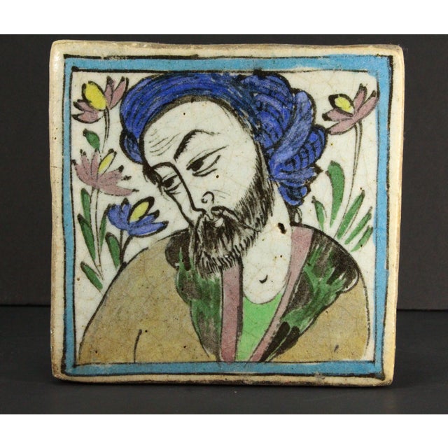 An impressive early glazed earthenware tile Masterly painted underglaze portrait of a man in traditional attire, looking...