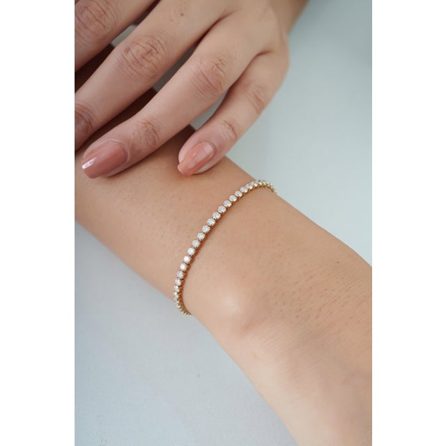 This diamond tennis bracelet showcases 3.49 carats of natural round brilliant diamonds set in 14K Yellow Gold. Each...