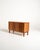 Swedish teak storage cabinet with a side-sliding shutter, two internal compartments, and adjustable metal shelves....