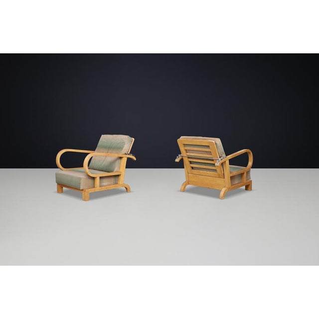 This exquisite set of two Art Deco reclining lounge chairs, crafted from birch wood and featuring original upholstery,...