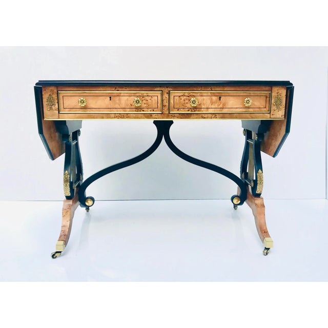 Exquisite writing desk/library table by Baker. The desk is well finished on its four faces in Yew Wood Venner, applied in...